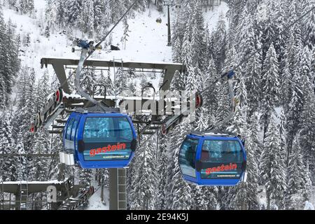 BAD HOFGASTEIN, AUSTRIA - MARCH 7, 2016: People ride Kaserebenbahn gondola ski lift in Bad Hofgastein. It is part of Ski Amade, one of largest ski reg Stock Photo