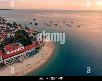 Zanzibar Aerial Shot of Stone Town Beach with Traditional Dhow Fisherman Boats in the Ocean at Sunset Time Stock Photo