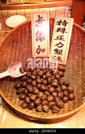 KYOTO, JAPAN - APRIL 14, 2012: Roasted chestnuts stall in Kyoto city, Japan. It is a typical street food in Kyoto. Stock Photo