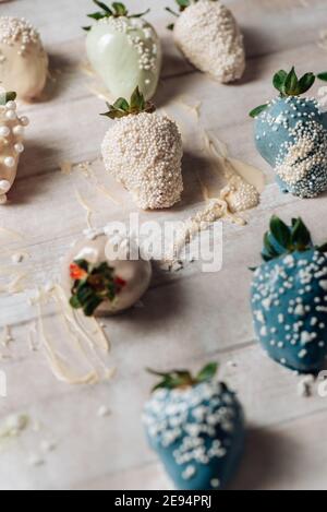 Step by step. Tasty Blue and white chocolate dipped strawberries with sugar sprinkles on wodd background. valentine´s day Stock Photo