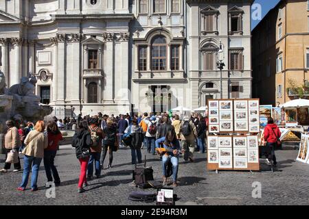ROME, ITALY - APRIL 10, 2012: Tourists visit Piazza Navona in Rome. According to official data Rome was visited by 12.6 million people in 2013. Stock Photo