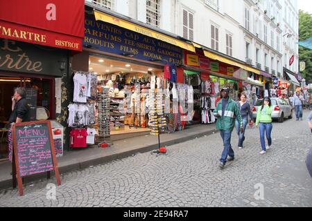 PARIS, FRANCE - JULY 22, 2011: Tourists walk Rue de Steinkerque in Paris, France. The street is one of most famous shopping areas in Monmartre distric Stock Photo