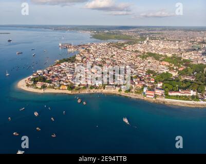 Zanzibar Aerial Shot of Stone Town Beach with Traditional Dhow Fisherman Boats in the Ocean at Sunset Time Stock Photo