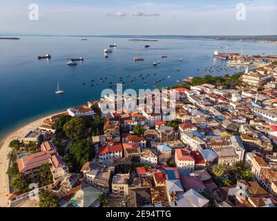 Zanzibar Aerial Shot of Stone Town Beach with Traditional Dhow Fisherman Boats in the Ocean at Sunset Time Stock Photo