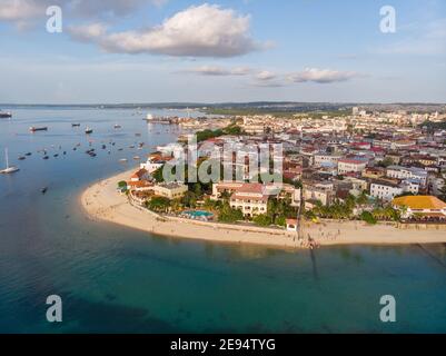 Zanzibar Aerial Shot of Stone Town Beach with Traditional Dhow Fisherman Boats in the Ocean at Sunset Time Stock Photo