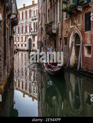 Venice, Italy, Sept. 11, 2020 – A couple enjoying a gondola tour in Venice Stock Photo