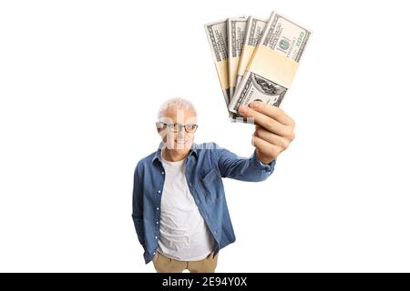 Mature man holding money banknotes in front of camera isolated on white background Stock Photo