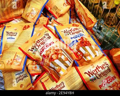 Berlin, Germany - February 2, 2021: View to different packages of popcorn in a supermarket. Stock Photo