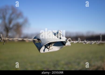 Tensioner for barbed wire in winter. No trespassing.  Stock Photo