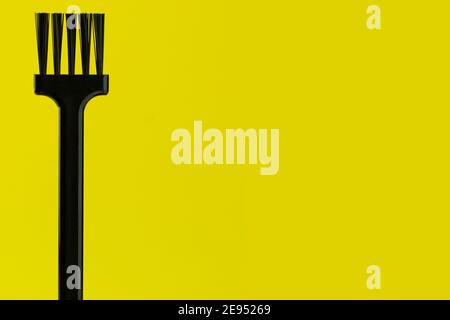 Black and hard brush on a yellow background. Brush isolated with clipping path Stock Photo