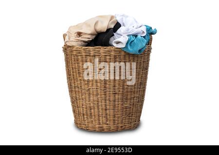 Clothes in a laundry wooden basket isolated on white background. Overflowing laundry basket. clipping path Stock Photo