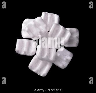 Top view of of m-shaped styrofoam packing chips isolated on black Stock Photo