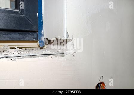 Forged place in the wall under the window, prepared for installing a window sill inside the house. Stock Photo