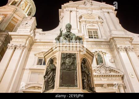 View of the monument to Pope Sixtus the fifth, the consecration of a bronze statue from a chair and the Basilica of Santa Casa at night. A popular Stock Photo