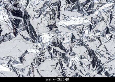 Abstract silver crumpled foil background. Minimal party concept. Stock Photo