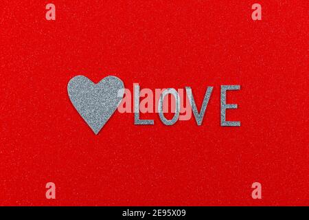 Love Text And Silver Heart On Textured Red Stock Photo
