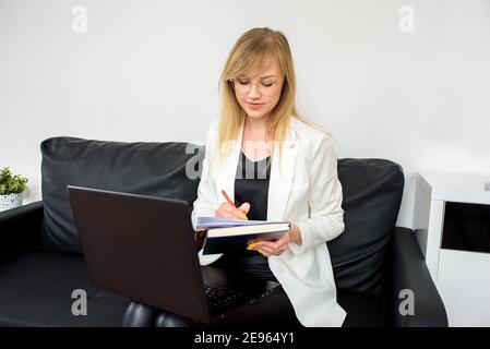 online consultation of lawyer, accountant.businesswoman working on laptop, successful confident executive manager sitting at office, young e-business Stock Photo