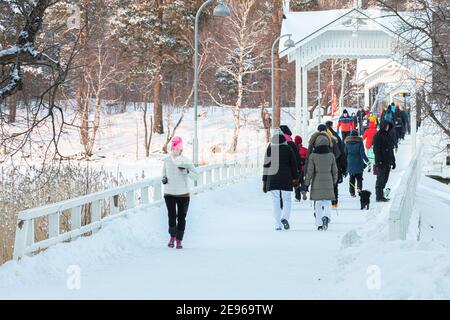 Seurasaari, Helsinki. Finland January 31, 2021. People walk across the bridge. Healthy lifestyle concept. Walk to the sea. High quality photo Stock Photo
