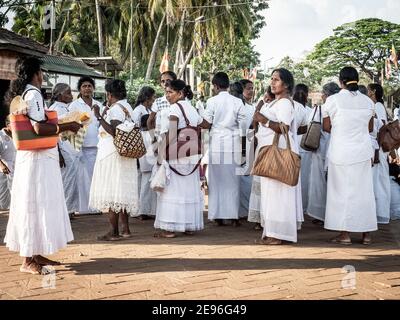 ANURADHAPURA, SRI LANKA - March 9, 2019: Group of women in white dress in ancient city. Stock Photo