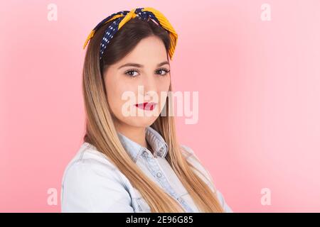 portrait of a young blonde woman with pin up look Stock Photo