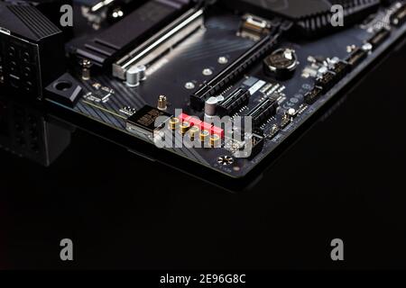The motherboard on a table close-up, inside of a desktop computer showing chips, circuit boards and components with copy space. Stock Photo