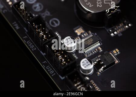 Motherboard on a table close-up, inside of a desktop computer showing chips, circuit boards and components Stock Photo