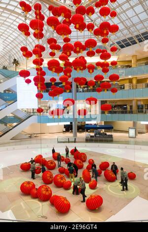 Dallas, USA. 2nd Feb, 2021. Staff members install red lanterns in Galleria Dallas shopping mall in Dallas, Texas, the United States, on Feb. 2, 2021. Over 200 red lanterns, as decorations for the upcoming Chinese Lunar New Year, are hung above the shopping mall's ice skating rink from Feb. 2 to March 2. Credit: Dan Tian/Xinhua/Alamy Live News Stock Photo