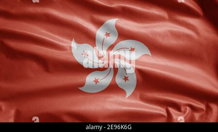 Hongkong flag waving in the wind. Close up of Hong Kong banner blowing, soft and smooth silk. Cloth fabric texture ensign background. Use it for natio Stock Photo