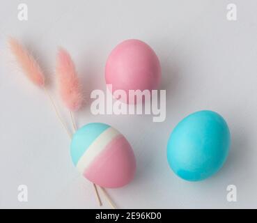 Delicate colors of Easter eggs on a white table, top view Stock Photo