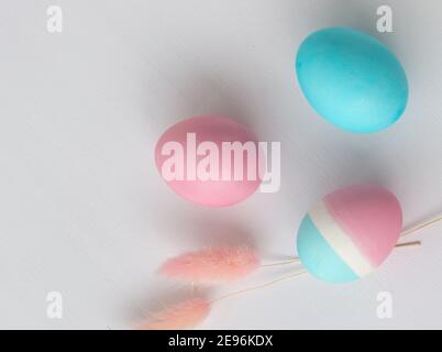 Delicate colors of Easter eggs on a white table, close-up Stock Photo