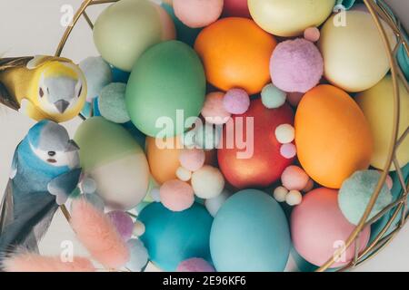 Many colored easter eggs in a basket on the table Stock Photo