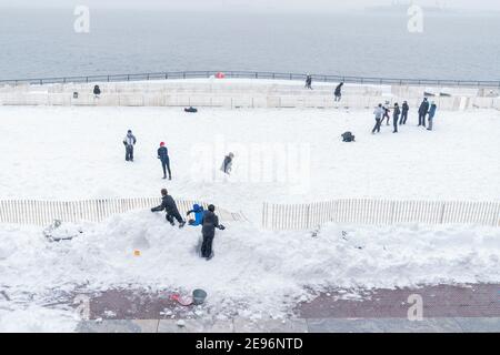 New York, United States. 02nd Feb, 2021. Kids and adults play in Battery Park covered with snow after major snowfall the day before brought more than foot on the ground in New York on February 2, 2021. (Photo by Lev Radin/Sipa USA) Credit: Sipa USA/Alamy Live News Stock Photo