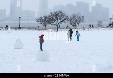 New York, United States. 02nd Feb, 2021. Kids and adults play in Battery Park covered with snow after major snowfall the day before brought more than foot on the ground in New York on February 2, 2021. (Photo by Lev Radin/Sipa USA) Credit: Sipa USA/Alamy Live News Stock Photo