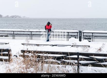 New York, United States. 02nd Feb, 2021. A photographer seen in Battery Park covered with snow after major snowfall the day before brought more than foot on the ground in New York on February 2, 2021. (Photo by Lev Radin/Sipa USA) Credit: Sipa USA/Alamy Live News Stock Photo