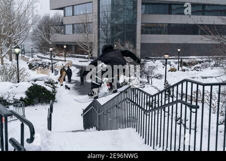 New York, United States. 02nd Feb, 2021. A young man showing his snowboarding skills in Battery Park after major snowfall the day before left more than a foot on the ground in New York on February 2, 2021. (Photo by Lev Radin/Sipa USA) Credit: Sipa USA/Alamy Live News Stock Photo