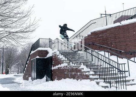 New York, United States. 02nd Feb, 2021. A young man showing his snowboarding skills in Battery Park after major snowfall the day before left more than a foot on the ground in New York on February 2, 2021. (Photo by Lev Radin/Sipa USA) Credit: Sipa USA/Alamy Live News Stock Photo