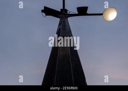 Low angle view of black lamppost under dark blue sky Stock Photo