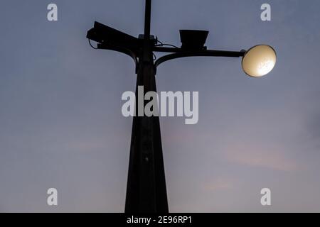 Low angle view of black lamppost under dark blue sky Stock Photo