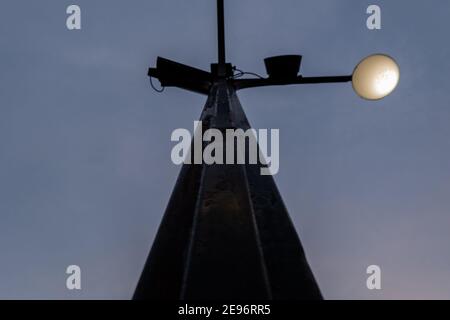 Low angle view of black lamppost under dark blue sky Stock Photo