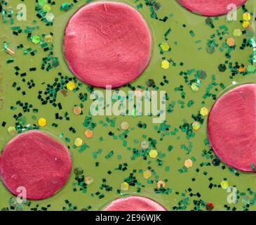 Hand painted pink circles on green with green glitter background Stock Photo
