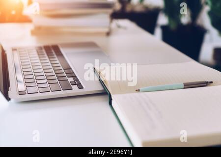 Working space on clean nature workspace at home with laptop, planner notebook and calculator. Business finance office concept. Stock Photo