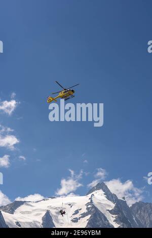 Grossglockner, Austria - Aug 8, 2020: Emergency helicopter rescue ski accident in the mountain Stock Photo