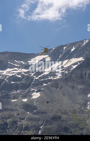 Grossglockner, Austria - Aug 8, 2020: Emergency helicopter rescue ski accident in the mountain Stock Photo