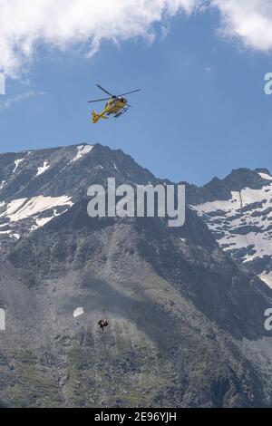 Grossglockner, Austria - Aug 8, 2020: Emergency helicopter rescue ski accident in the mountain Stock Photo