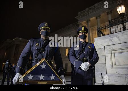 Washington, United States. 02nd Feb, 2021. U.S. Capitol Police wait with a flag for the family at the U.S. Capitol on Tuesday, February 2, 2021 in Washington, DC. Sicknick died as a result of injuries sustained during the January 6 attack on the Capitol Building. Sicknic's remains will lie in honor through tomorrow, and then be buried at Arlington National Cemetery. Pool photo by Tasos Katopodis/UPI Credit: UPI/Alamy Live News Stock Photo