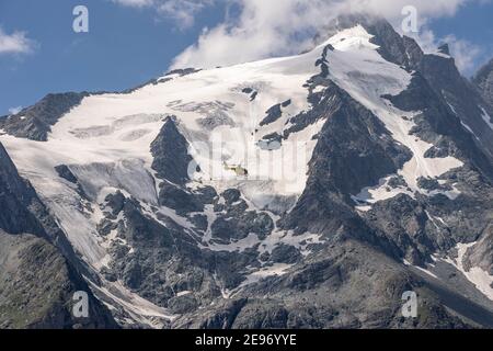 Grossglockner, Austria - Aug 8, 2020: Emergency helicopter rescue ski accident in the mountain Stock Photo