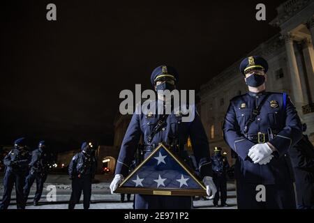 Washington, United States. 02nd Feb, 2021. Capitol Police Honor Cordon wait with a flag for the family at the U.S. Capitol on Tuesday, February 2, 2021 in Washington, DC. Sicknick died as a result of injuries sustained during the January 6 attack on the Capitol Building. Sicknic's remains will lie in honor through tomorrow, and then be buried at Arlington National Cemetery. Pool photo by Tasos Katopodis/UPI Credit: UPI/Alamy Live News Stock Photo