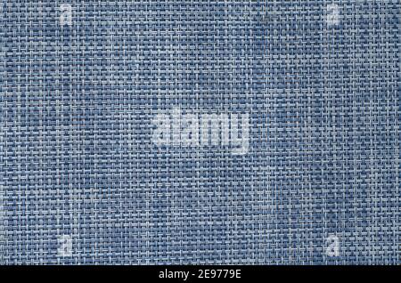 Texture of woven synthetic fabric. Detailed shot of cross-linked blue and white threads. Weaving pattern of interwoven fibers. Stock Photo