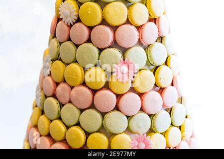 Tower of sweet and colourful french macaroons, flower ornament, backlit, detail Stock Photo