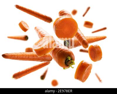 Ripe carrots whole and sliced levitate on a white background Stock Photo